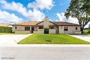 13100 S Mccall Rd Unit 112, Port Charlotte, FL 33981 - ranch-style home with a front yard and concrete driveway