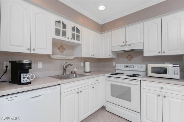 13100 S Mccall Rd Unit 112, Port Charlotte, FL 33981 - kitchen featuring under cabinet range hood, white appliances, white cabinetry, tasteful backsplash, and ornamental molding