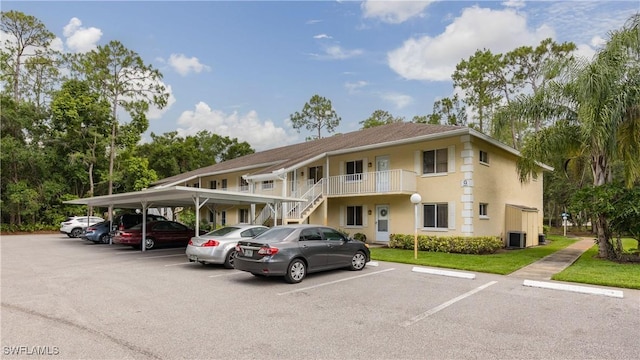 3451 County Barn Rd Unit G103, Naples, FL 34112 - view of building exterior with covered and uncovered parking and stairway