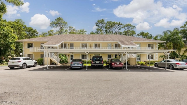 3451 County Barn Rd Unit G103, Naples, FL 34112 - view of property with stairway and covered and uncovered parking