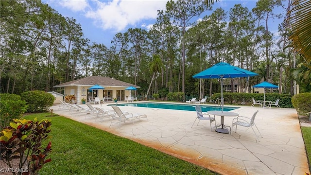 3451 County Barn Rd Unit G103, Naples, FL 34112 - community pool with a patio area, an outbuilding, and view of scattered trees