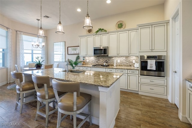 2977 Willow Ridge Ct, Fort Myers, FL 33905 - kitchen featuring stainless steel appliances, tasteful backsplash, a chandelier, a center island with sink, and recessed lighting