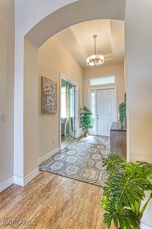2977 Willow Ridge Ct, Fort Myers, FL 33905 - entrance foyer with a raised ceiling, wood finished floors, arched walkways, a chandelier, and a textured wall