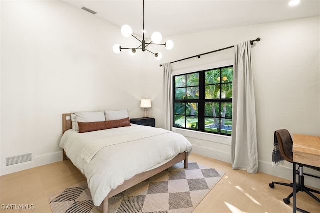 7658 Ponte Verde Way, Naples, FL 34109 - bedroom featuring a chandelier and light wood-style floors