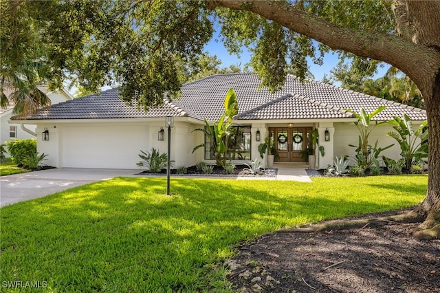 7658 Ponte Verde Way, Naples, FL 34109 - view of front of house featuring french doors, a tile roof, a garage, and stucco siding