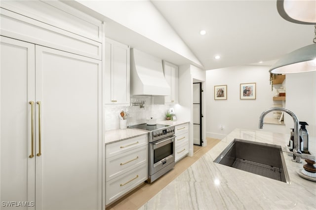 7658 Ponte Verde Way, Naples, FL 34109 - kitchen featuring stainless steel electric stove, wall chimney range hood, white cabinetry, tasteful backsplash, and light stone counters