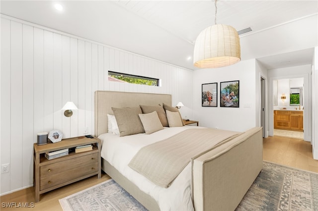 7658 Ponte Verde Way, Naples, FL 34109 - bedroom with wood finished floors, recessed lighting, and ensuite bath
