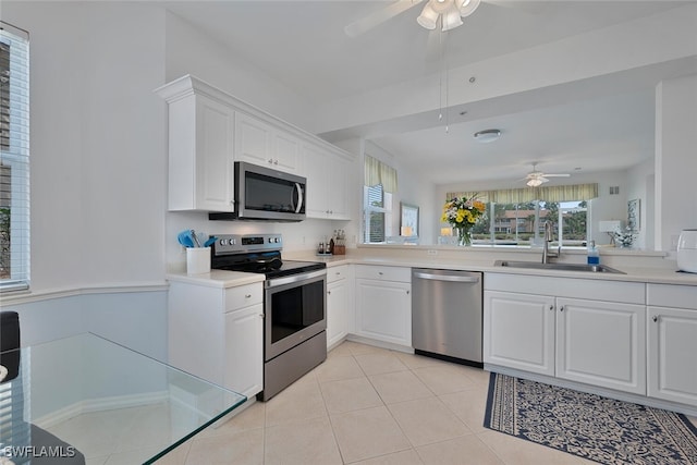 3993 Bishopwood Ct E Unit 101, Naples, FL 34114 - kitchen with stainless steel appliances, ceiling fan, white cabinets, and light countertops
