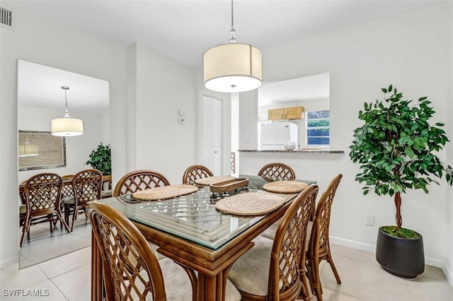 1100 8th Ave S Unit 211B, Naples, FL 34102 - dining space with light tile patterned floors and baseboards
