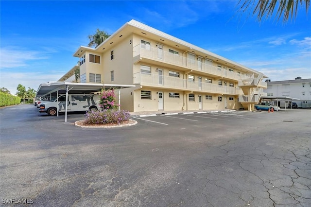 1100 8th Ave S Unit 211B, Naples, FL 34102 - view of building exterior featuring covered and uncovered parking