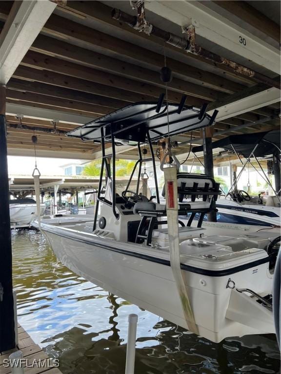 1100 8th Ave S Unit 211B, Naples, FL 34102 - dock area featuring boat lift