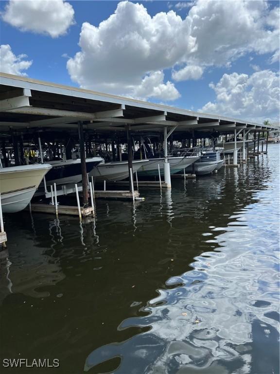 1100 8th Ave S Unit 211B, Naples, FL 34102 - dock area featuring boat lift and a water view