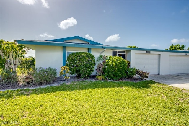 5549 Westwind Ln, Fort Myers, FL 33919 - view of front of property with a garage, stucco siding, a front yard, and driveway