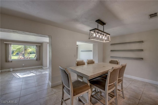 5549 Westwind Ln, Fort Myers, FL 33919 - dining room featuring light tile patterned flooring and a chandelier