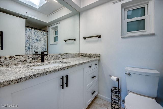 5549 Westwind Ln, Fort Myers, FL 33919 - full bath with vanity, tile patterned floors, and a skylight