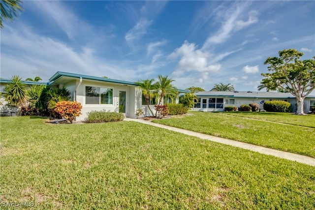 5549 Westwind Ln, Fort Myers, FL 33919 - view of front of home with a front yard and stucco siding