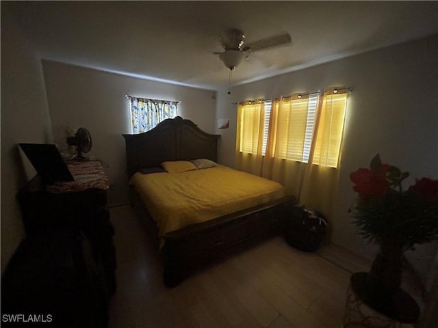 4920 Cortez Cir, Naples, FL 34112 - bedroom with wood finished floors and a ceiling fan