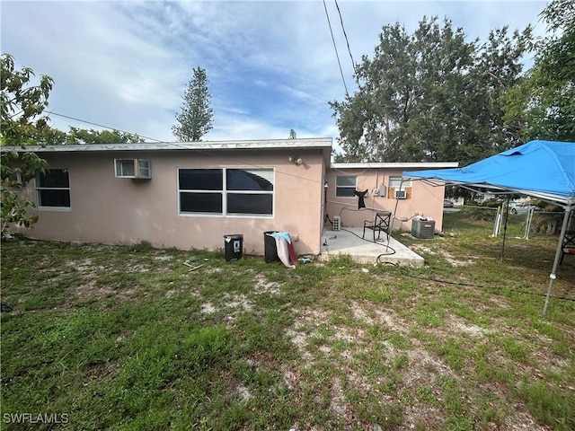 4920 Cortez Cir, Naples, FL 34112 - rear view of house featuring a patio area, stucco siding, and a wall mounted AC
