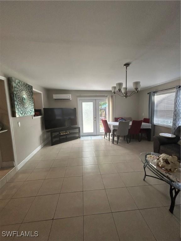 4920 Cortez Cir, Naples, FL 34112 - living area with a chandelier, a wall unit AC, and tile patterned flooring