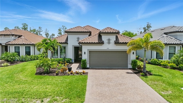 17467 Caravita Ln, Fort Myers, FL 33913 - mediterranean / spanish-style house with an attached garage, stucco siding, a tiled roof, and a front lawn