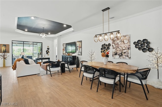 17467 Caravita Ln, Fort Myers, FL 33913 - dining area featuring a raised ceiling, light wood-style floors, ornamental molding, a chandelier, and recessed lighting