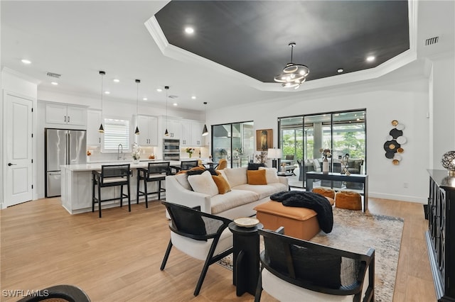 17467 Caravita Ln, Fort Myers, FL 33913 - living area with a raised ceiling, crown molding, light wood finished floors, and recessed lighting