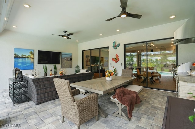 17467 Caravita Ln, Fort Myers, FL 33913 - dining room with a ceiling fan, recessed lighting, and stone finish floors