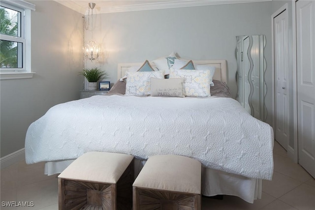 960 7th St S Unit 202, Naples, FL 34102 - bedroom with ornamental molding, tile patterned flooring, and a chandelier