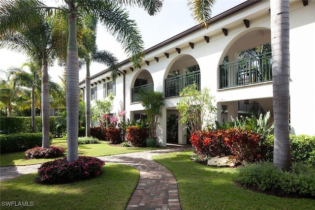960 7th St S Unit 202, Naples, FL 34102 - view of front of property with a front yard, stucco siding, and a balcony