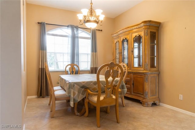 892 Grand Rapids Blvd, Naples, FL 34120 - dining area with a chandelier, light tile patterned floors, and baseboards