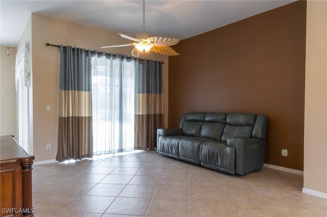 892 Grand Rapids Blvd, Naples, FL 34120 - living area with healthy amount of natural light, light tile patterned floors, a ceiling fan, and baseboards