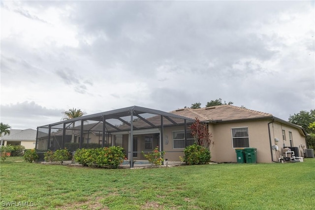 892 Grand Rapids Blvd, Naples, FL 34120 - back of house with a yard, stucco siding, a tiled roof, and central air condition unit
