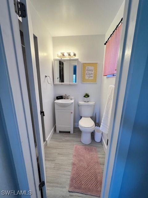 1661 Coronado Rd, Fort Myers, FL 33901 - bathroom with vanity and wood finished floors