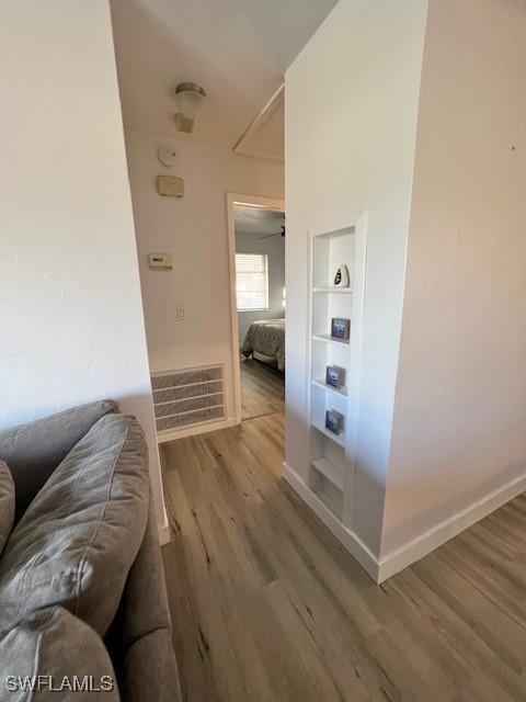 1661 Coronado Rd, Fort Myers, FL 33901 - hall featuring wood finished floors, built in features, and attic access