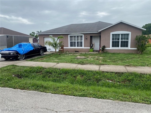 1116 Bent Creek Loop, Fort Myers, FL 33916 - ranch-style home featuring an attached garage, stucco siding, a shingled roof, driveway, and a front yard
