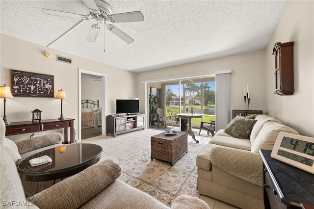7152 Blanquilla Ct Unit 5, Fort Myers, FL 33908 - living area with a textured ceiling, ceiling fan, and light tile patterned floors