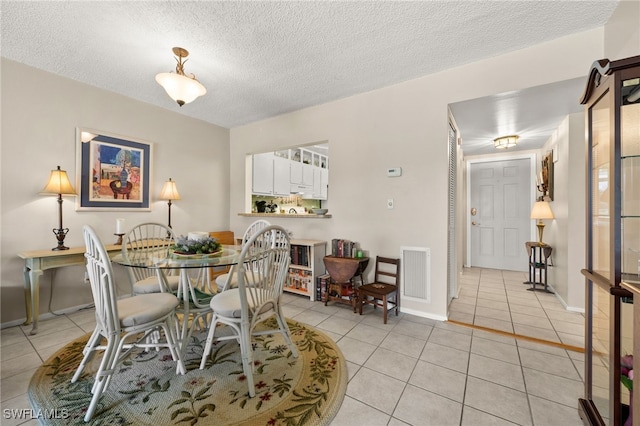 7152 Blanquilla Ct Unit 5, Fort Myers, FL 33908 - dining room with light tile patterned floors and a textured ceiling