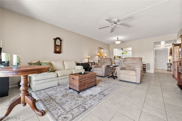 7152 Blanquilla Ct Unit 5, Fort Myers, FL 33908 - living room with light tile patterned floors, a ceiling fan, and a textured ceiling