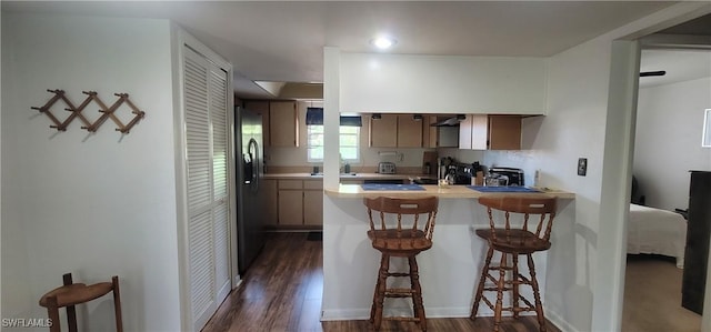 4213 SE 19th Ave Unit 208, Cape Coral, FL 33904 - kitchen featuring stainless steel fridge, a peninsula, dark wood-style flooring, and light countertops