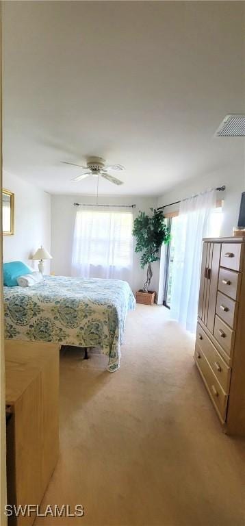 4213 SE 19th Ave Unit 208, Cape Coral, FL 33904 - bedroom with multiple windows, light colored carpet, and ceiling fan