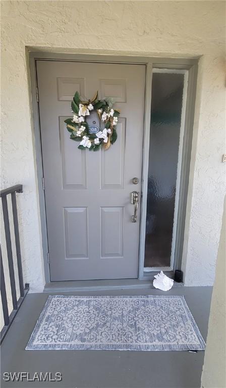 4213 SE 19th Ave Unit 208, Cape Coral, FL 33904 - property entrance with stucco siding