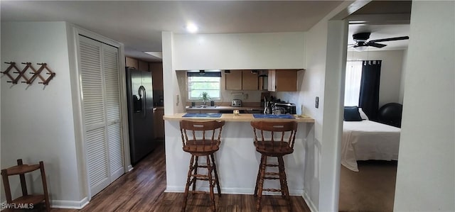 4213 SE 19th Ave Unit 208, Cape Coral, FL 33904 - kitchen with stainless steel refrigerator with ice dispenser, dark wood finished floors, a peninsula, a kitchen bar, and ceiling fan