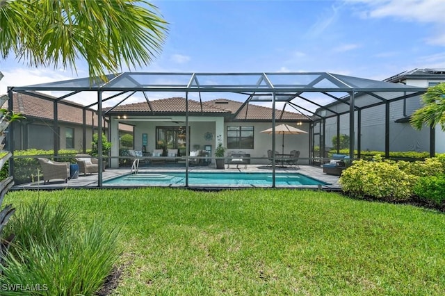4012 E Hampton Cir, Alva, FL 33920 - back of property with ceiling fan, a yard, stucco siding, a tiled roof, and an outdoor pool