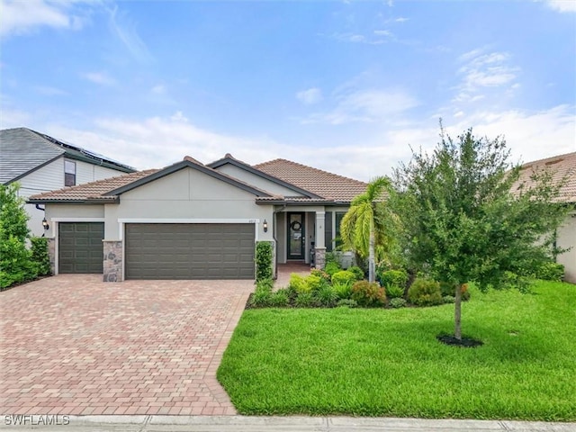4012 E Hampton Cir, Alva, FL 33920 - ranch-style home with an attached garage, stucco siding, a front yard, decorative driveway, and stone siding