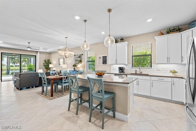 4012 E Hampton Cir, Alva, FL 33920 - kitchen featuring recessed lighting, tasteful backsplash, a kitchen island, and plenty of natural light