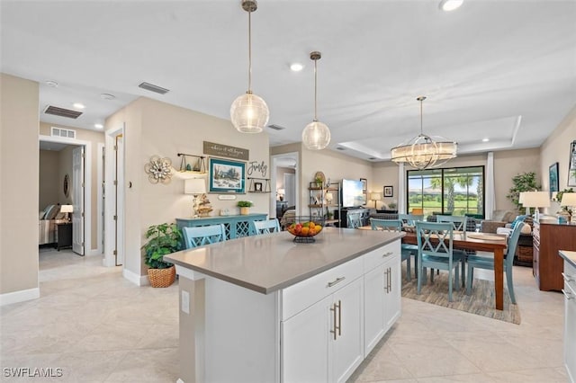 4012 E Hampton Cir, Alva, FL 33920 - kitchen with open floor plan, a kitchen island, white cabinetry, recessed lighting, and hanging light fixtures