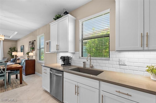4012 E Hampton Cir, Alva, FL 33920 - kitchen with stainless steel dishwasher, decorative backsplash, open floor plan, white cabinets, and light tile patterned flooring