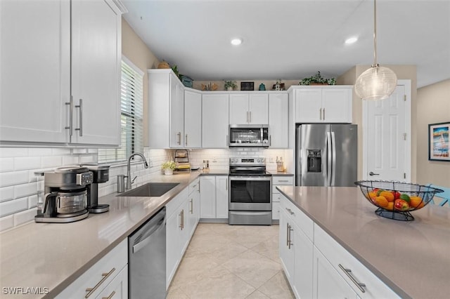 4012 E Hampton Cir, Alva, FL 33920 - kitchen with stainless steel appliances, tasteful backsplash, white cabinets, recessed lighting, and hanging light fixtures