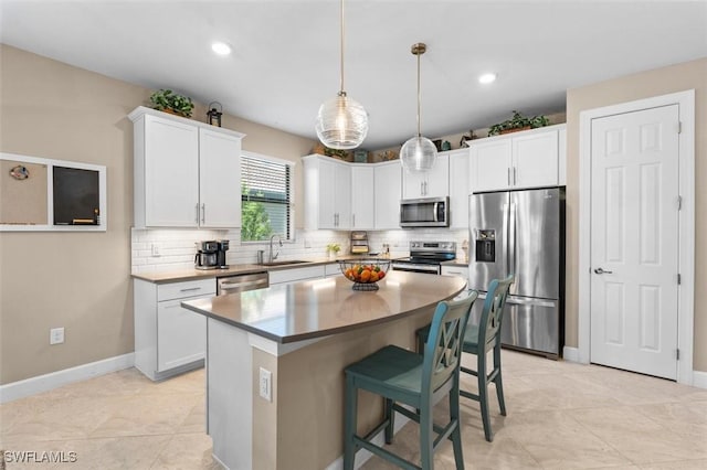 4012 E Hampton Cir, Alva, FL 33920 - kitchen with appliances with stainless steel finishes, decorative backsplash, a breakfast bar area, a center island, and recessed lighting