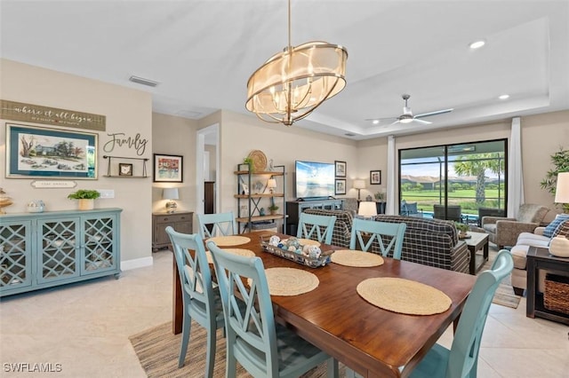 4012 E Hampton Cir, Alva, FL 33920 - dining area featuring a tray ceiling, a chandelier, ceiling fan, light tile patterned floors, and recessed lighting